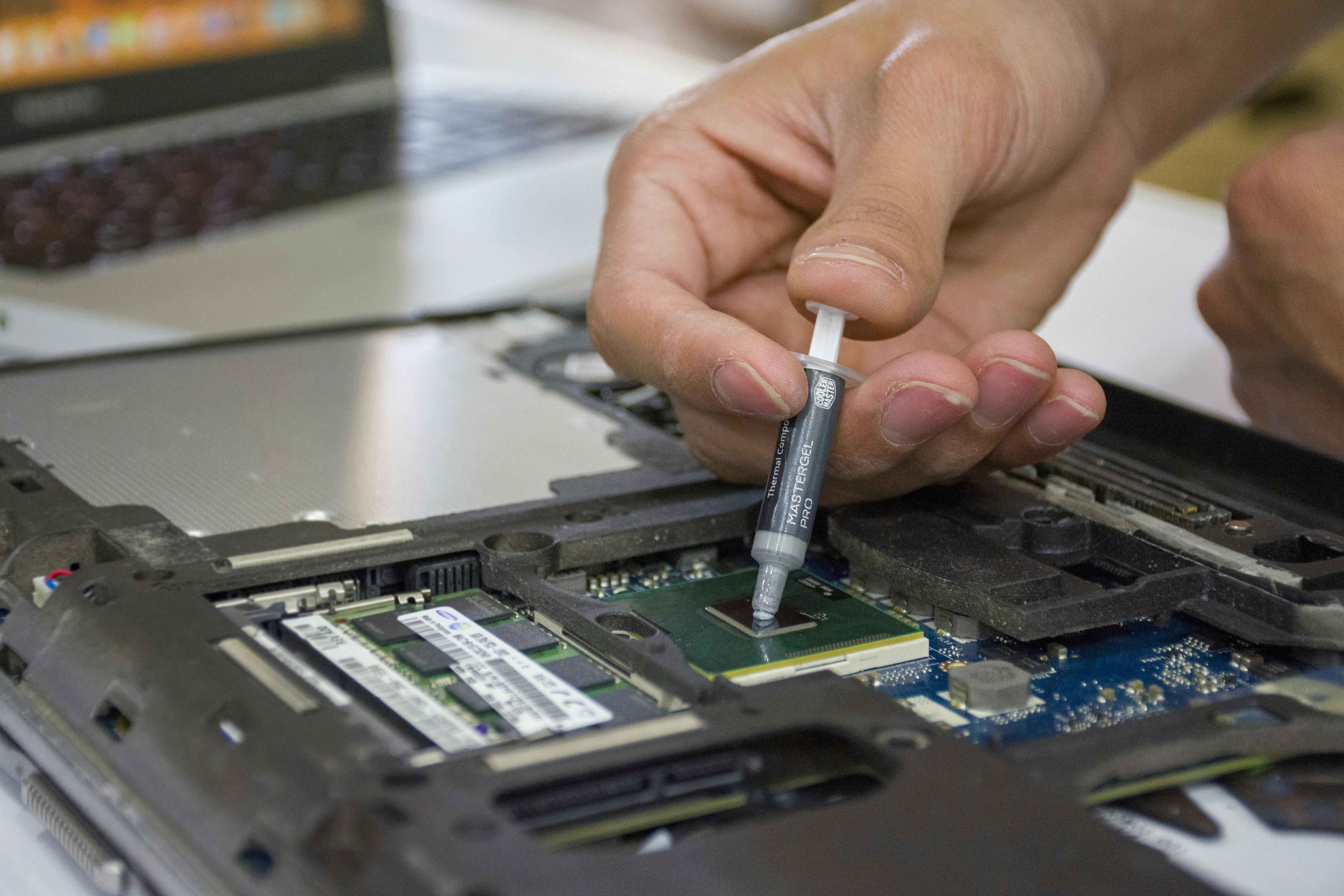 Technician changing the thermal paste on a CPU